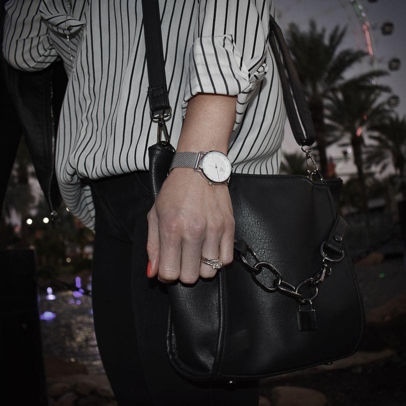 Detail shot of watch, ring, and purse