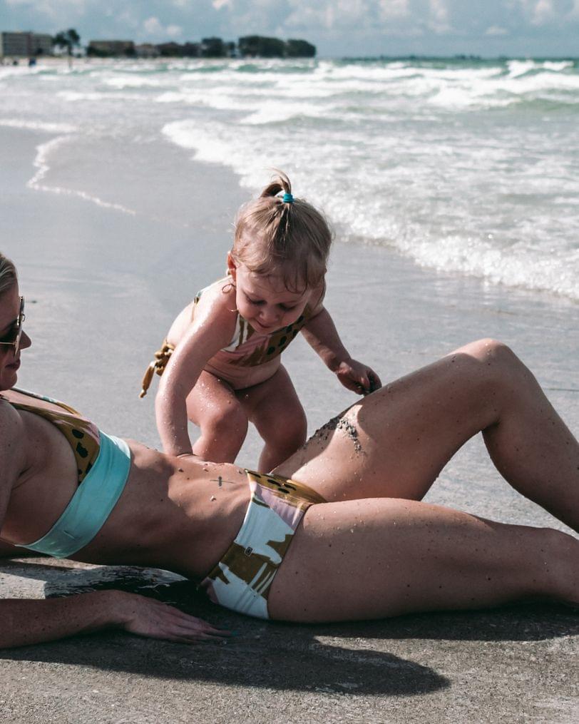 Building sandcastles on mommy - 2 of 2