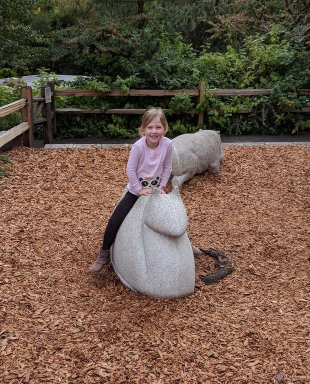 Cadence playing on a giant snail sculpture